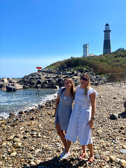 Weekend in The Hamptons: Two girls on beach in front of Montauk Point Lighthouse in Montauk, New York