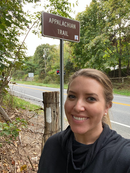 Woman and Appalachian Trail sign