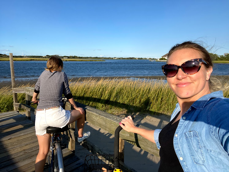 Weekend in The Hamptons: Two girls riding bikes on the Meadow Lane Boardwalk in Southampton, New York