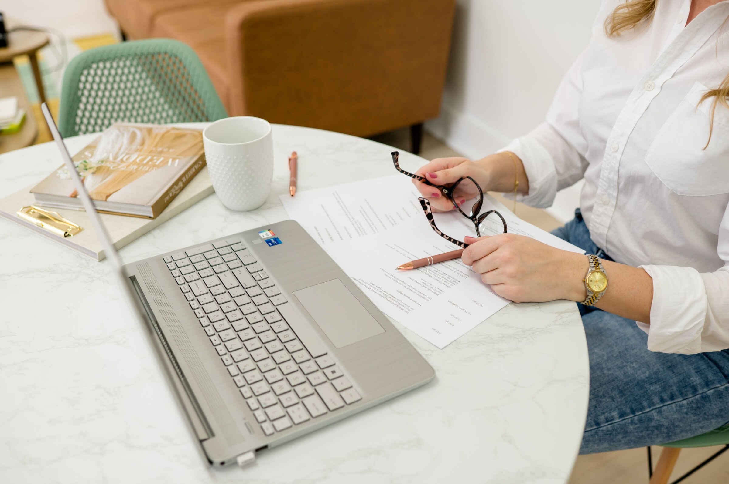Laptop and paperwork used to organize systems for wedding planners