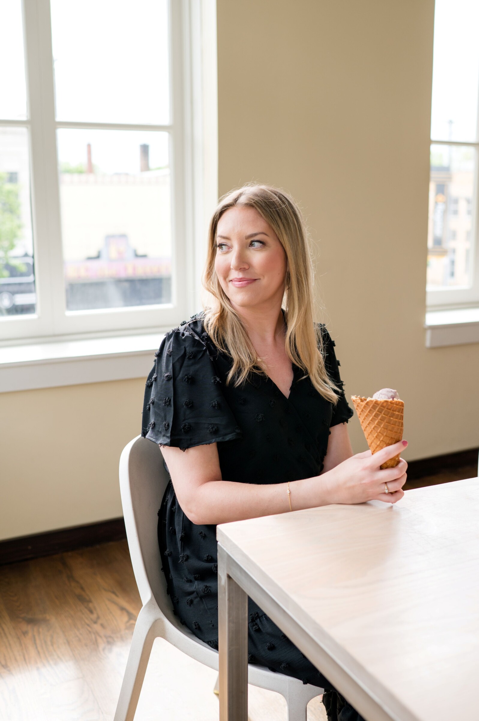 Darcy Warden seated at a table during a Being Darcy branding session