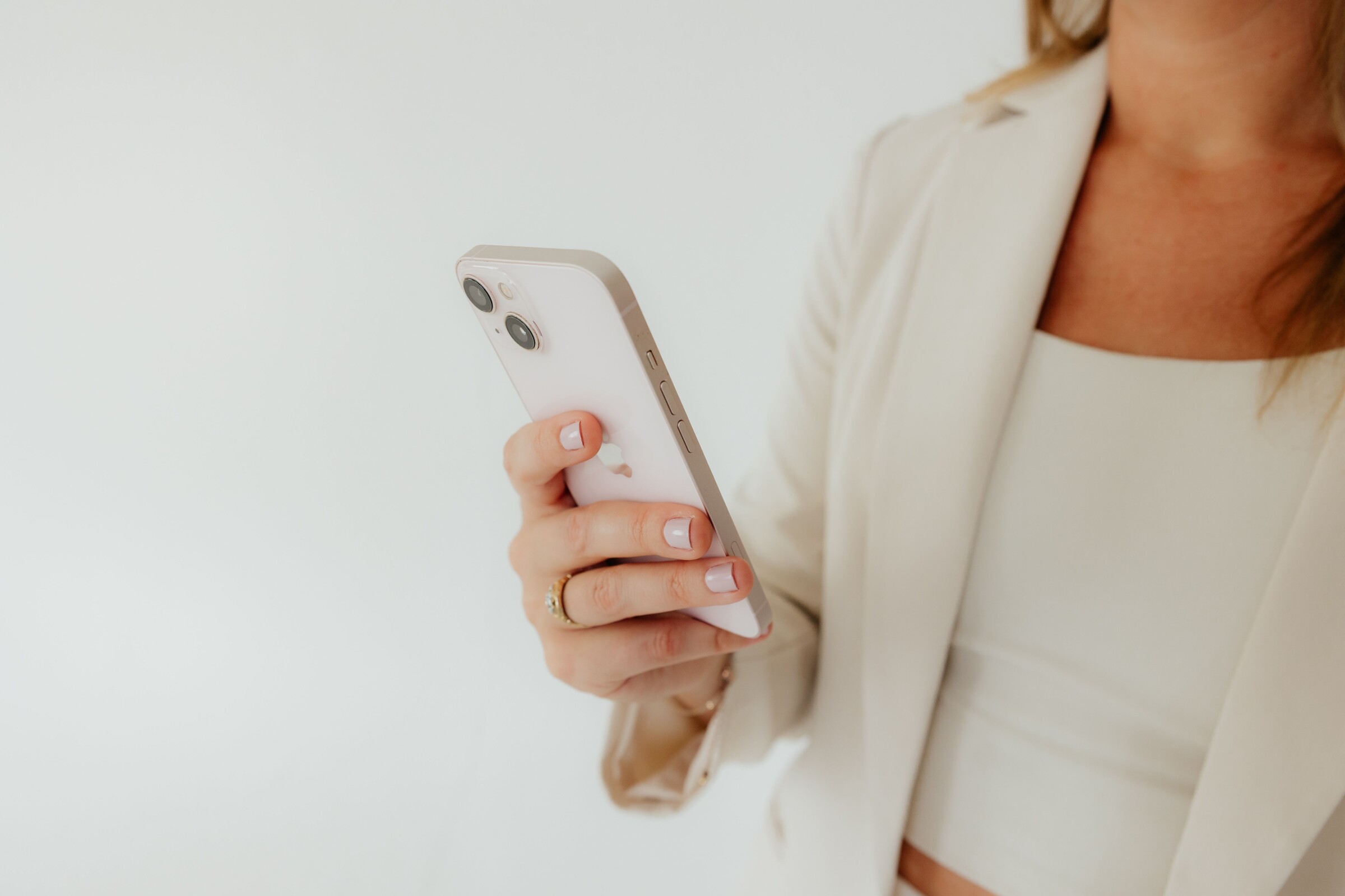 Business owner checking her phone while managing the mental load of running a business